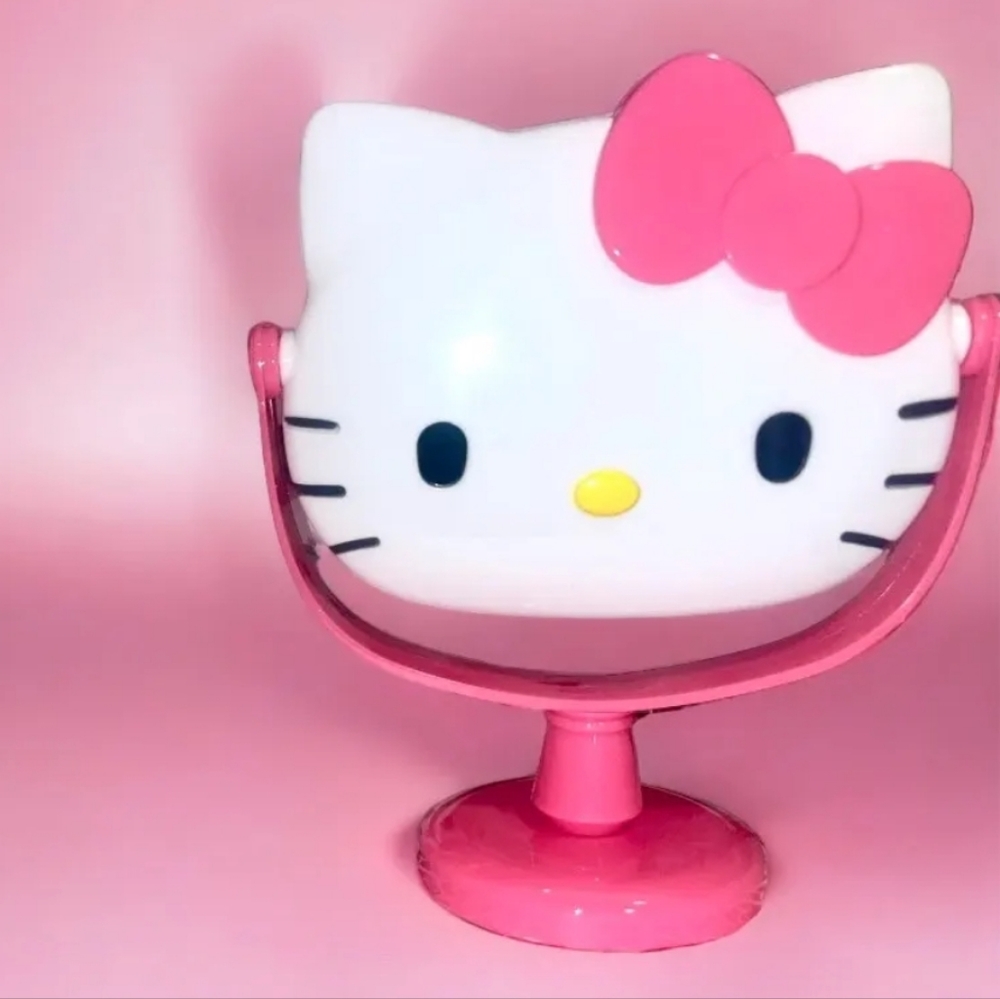 New Hello Kitty pink rotating makeup mirror approximately 9" tall.